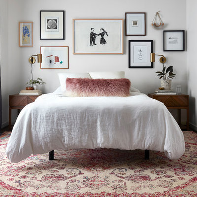 Example of an eclectic dark wood floor bedroom design in Dallas with white walls and no fireplace