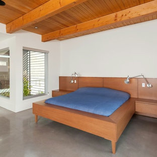 Diseño de dormitorio contemporáneo con suelo de cemento y suelo gris