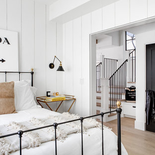 Inspiration for a coastal bedroom in Los Angeles with white walls, light hardwood flooring and beige floors.