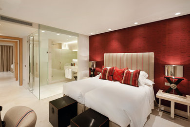 Design ideas for a contemporary master bedroom in London with red walls and beige floors.