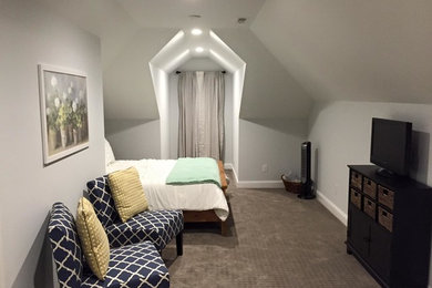 Example of a mid-sized transitional loft-style carpeted bedroom design in Charlotte with gray walls and no fireplace