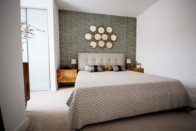 Medium sized contemporary master bedroom in Cambridgeshire with grey walls, carpet and beige floors.