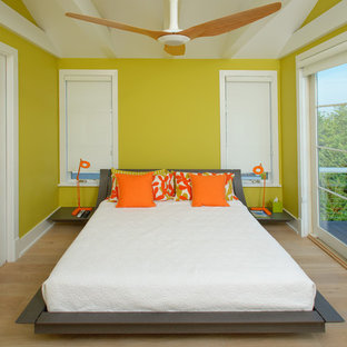 Contemporary guest bedroom in Wilmington with yellow walls and light hardwood floors.