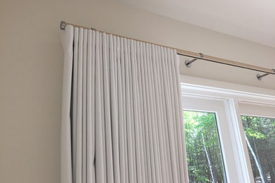 Example of a trendy master bedroom design in Portland Maine with white walls