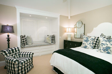 Example of a mid-sized classic guest carpeted bedroom design in Orange County with beige walls