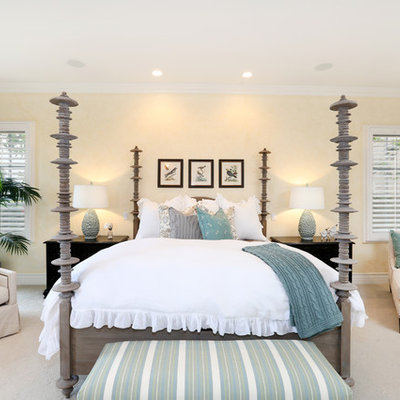 Mid-sized beach style master carpeted bedroom photo in Orange County with yellow walls and no fireplace