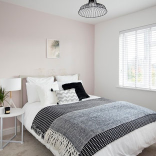 This is an example of a scandinavian bedroom in Other with pink walls, carpet, no fireplace and grey floors.
