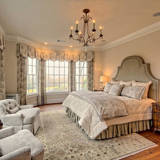 Inspiration for a mid-sized timeless master dark wood floor and brown floor bedroom remodel in Atlanta with beige walls and no fireplace