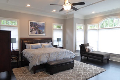 Inspiration for a large transitional master dark wood floor and brown floor bedroom remodel in Raleigh with gray walls and no fireplace
