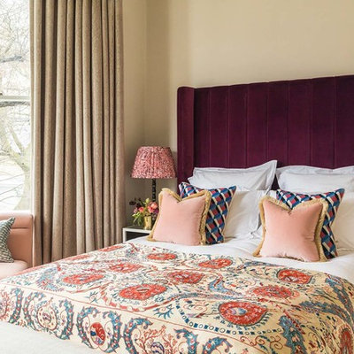 Example of a mid-sized classic bedroom design in London with beige walls