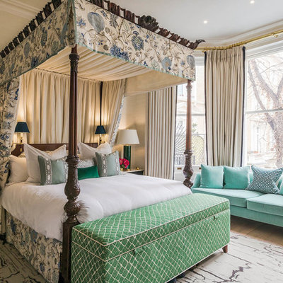 Example of a large classic master light wood floor and beige floor bedroom design in London with gray walls