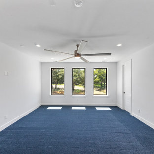 Example of a large trendy guest carpeted and blue floor bedroom design in Dallas with white walls
