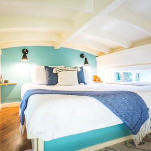Diseño de dormitorio marinero, pequeño, con paredes azules, suelo laminado y suelo marrón