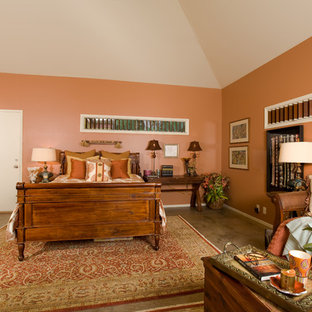 Ejemplo de habitación de invitados tropical, grande, con parades naranjas, suelo de cemento y suelo marrón