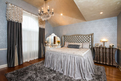Large ornate master medium tone wood floor and brown floor bedroom photo in New York with no fireplace and gray walls