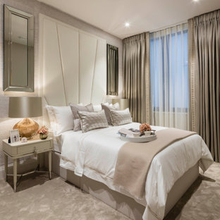 Photo of a classic guest bedroom in London with beige walls, carpet, no fireplace and beige floors.