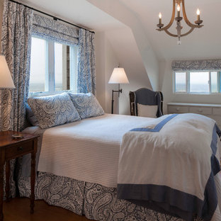 Inspiration for a coastal medium tone wood floor bedroom remodel in Seattle with white walls