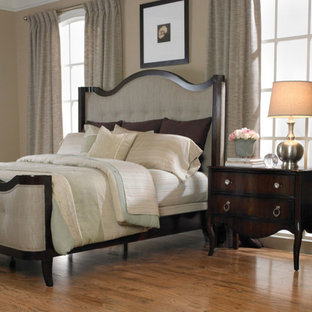 Large elegant master medium tone wood floor bedroom photo in Atlanta with beige walls and no fireplace