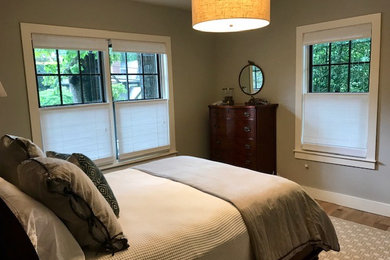 Inspiration for a mid-sized transitional guest light wood floor and beige floor bedroom remodel in Atlanta with gray walls and no fireplace