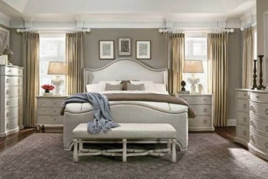 Example of a large medium tone wood floor bedroom design in Nashville with beige walls
