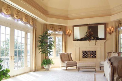 Inspiration for a large traditional master bedroom in Charlotte with white walls, carpet, a standard fireplace and a plastered fireplace surround.