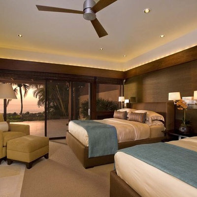 Example of an island style guest bedroom design in Hawaii with brown walls