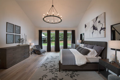 Inspiration for a large country master light wood floor and brown floor bedroom remodel in Atlanta with white walls
