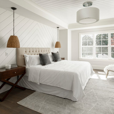 Large farmhouse master brown floor and dark wood floor bedroom photo in Charlotte with gray walls
