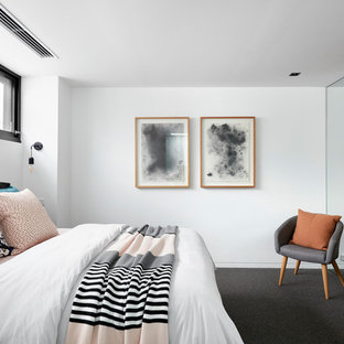 Photo of a contemporary bedroom in Melbourne with white walls, carpet and grey floor.