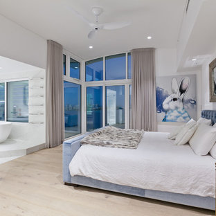 Photo of a large contemporary master bedroom in Perth with white walls, light hardwood floors and beige floor.