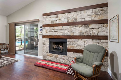 Example of a mid-sized trendy master bedroom design in Phoenix with a standard fireplace and a stone fireplace