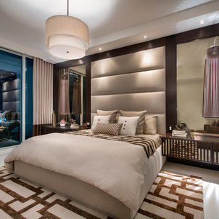 Inspiration for a large contemporary master porcelain tile bedroom remodel in Miami with no fireplace and beige walls