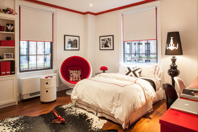 Example of a large eclectic medium tone wood floor and brown floor bedroom design in New York with white walls and no fireplace