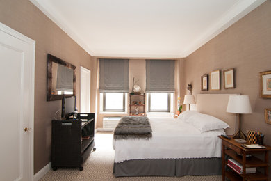 Large elegant master carpeted bedroom photo in New York with beige walls