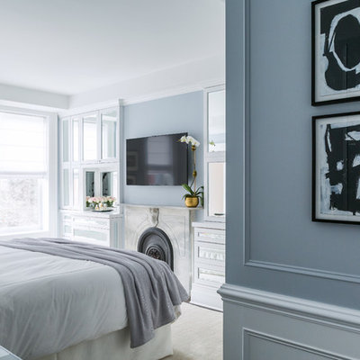 Bedroom - mid-sized transitional master dark wood floor bedroom idea in New York with gray walls, a standard fireplace and a stone fireplace