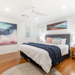 Inspiration for a contemporary bedroom in Other with white walls, medium hardwood floors and brown floor.