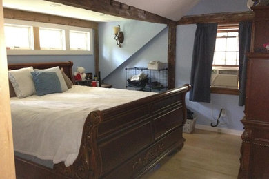 Inspiration for a small guest light wood floor bedroom remodel in Burlington with blue walls