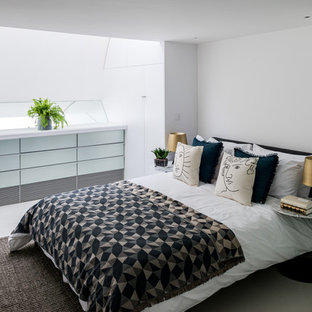 Contemporary bedroom in London with white walls, concrete flooring and grey floors.