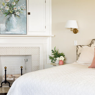 Example of a beach style guest dark wood floor bedroom design in Boston with a standard fireplace and a tile fireplace