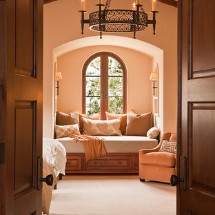 Design ideas for a mediterranean guest bedroom in San Francisco with beige walls, medium hardwood floors and brown floor.