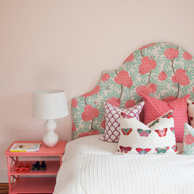 Example of an eclectic medium tone wood floor bedroom design in Philadelphia with beige walls