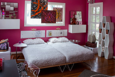 Imagen de dormitorio actual de tamaño medio con paredes rosas y suelo de madera en tonos medios