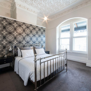 Expansive transitional master bedroom in Melbourne with black walls, carpet and grey floor.