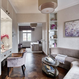Design ideas for a large traditional master bedroom in London with beige walls, dark hardwood flooring and brown floors.