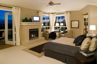 Example of a large transitional master carpeted bedroom design in Detroit with beige walls, a standard fireplace and a tile fireplace