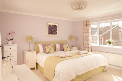 This is an example of a classic bedroom in Oxfordshire with purple walls, carpet and feature lighting.