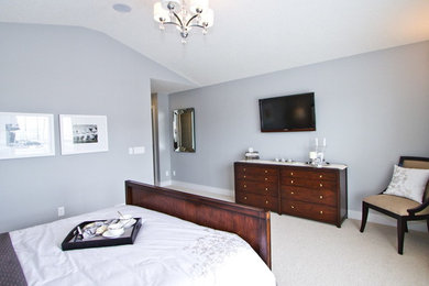 Example of a large trendy master carpeted and brown floor bedroom design in Calgary