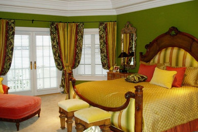 Ejemplo de dormitorio principal grande con paredes verdes y moqueta