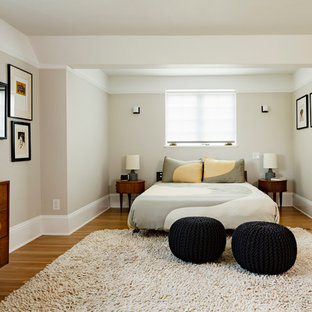 Bedroom - mid-sized contemporary master medium tone wood floor bedroom idea in Portland with beige walls