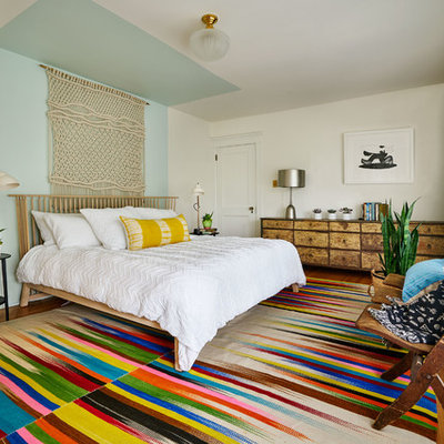 Inspiration for a mid-sized eclectic master medium tone wood floor bedroom remodel in Portland with multicolored walls and no fireplace